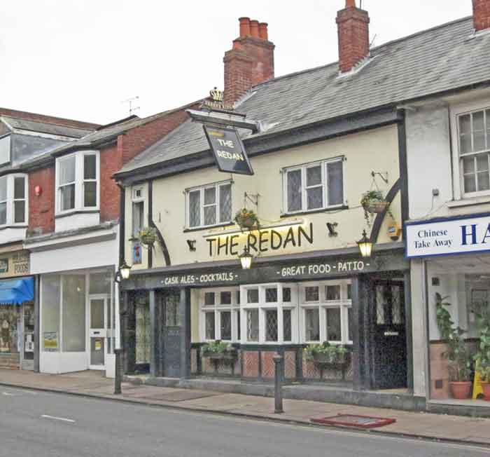pub in terrace of shops