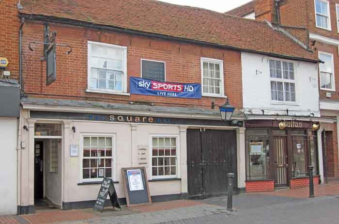 pub in terrace of shops
